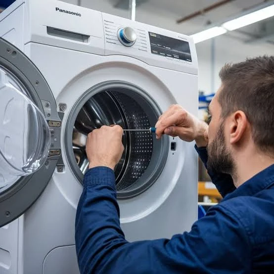 Technician inspecting a front-loading washing machine drum